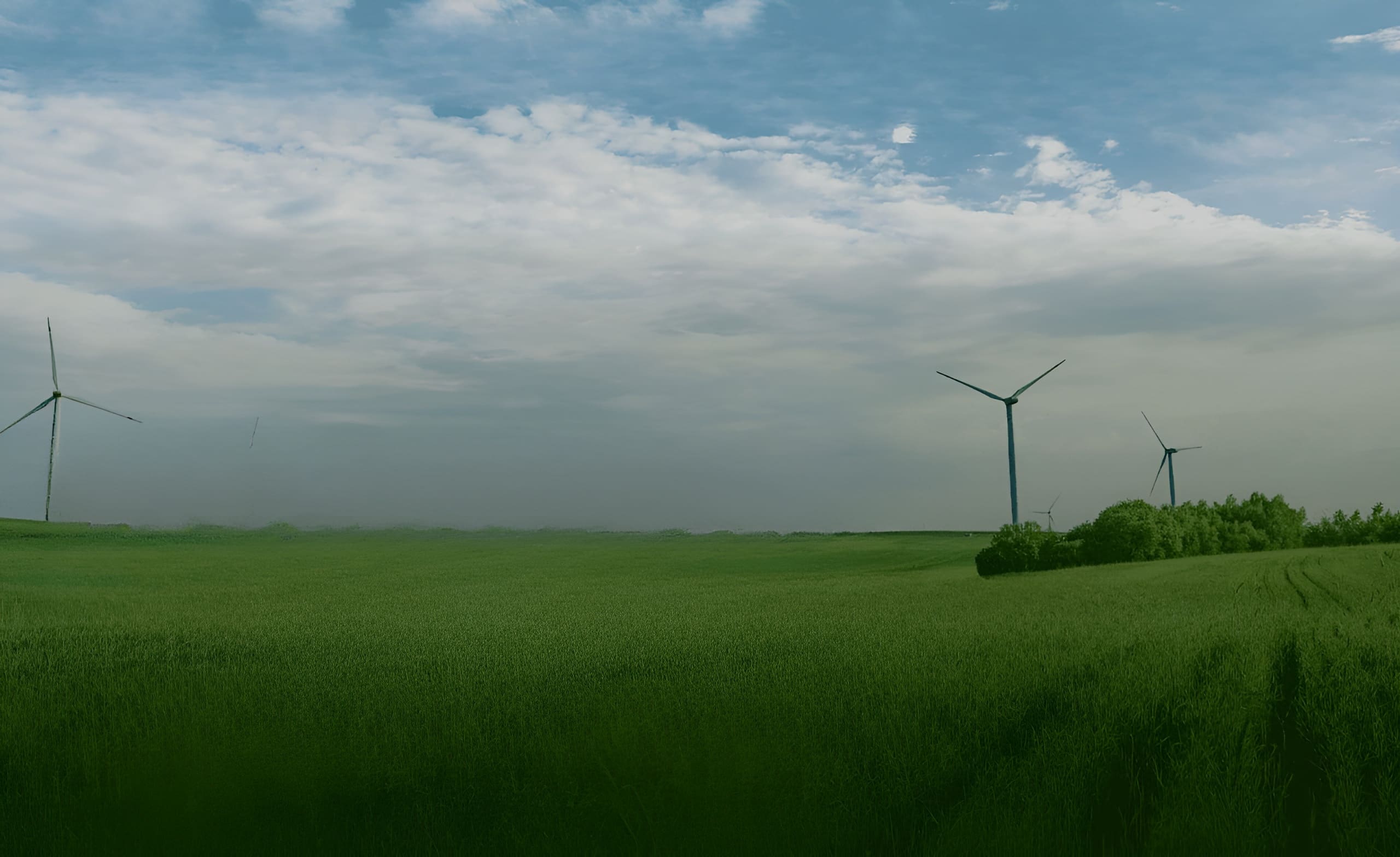 EVIGO® - Eine malerische grüne Wiese, geschmückt mit anmutigen Windturbinen, die die Kraft der Naturbrise nutzen.